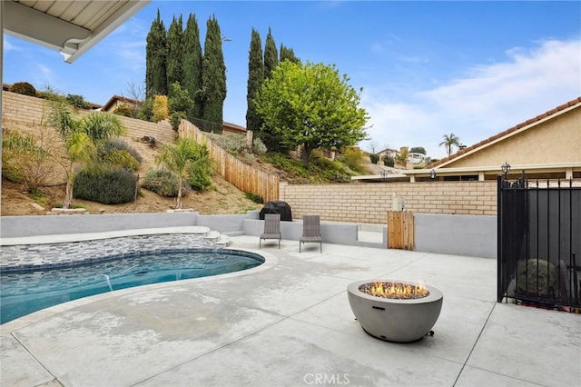 view of pool featuring a fenced in pool, an outdoor fire pit, a patio area, and a fenced backyard