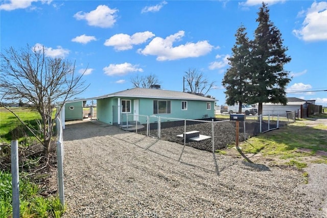 view of front of house featuring driveway and fence