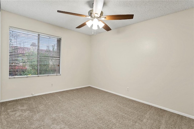 empty room with carpet, ceiling fan, a textured ceiling, and baseboards