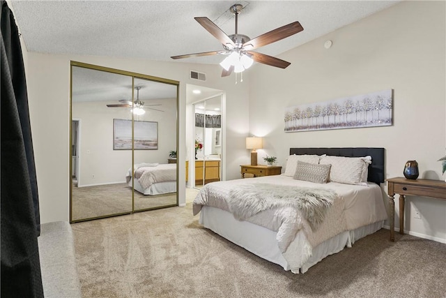 carpeted bedroom with lofted ceiling, a closet, visible vents, a ceiling fan, and a textured ceiling