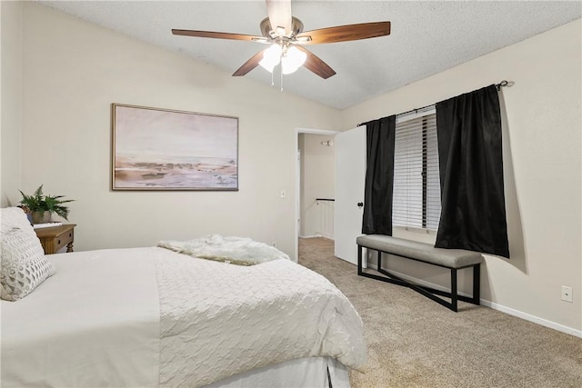 carpeted bedroom featuring lofted ceiling, ceiling fan, and baseboards