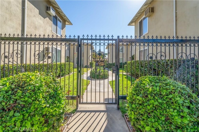 view of gate featuring a wall mounted AC