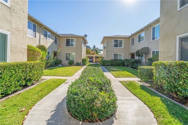 view of community featuring a residential view and a yard