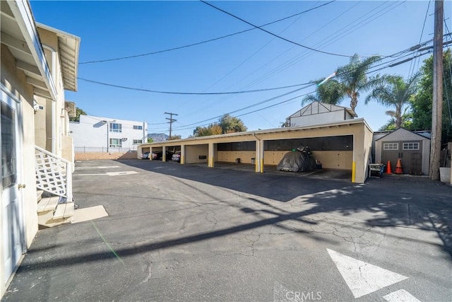 covered parking lot featuring a storage unit