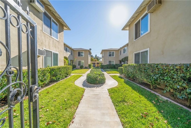 view of property's community featuring a residential view and a yard