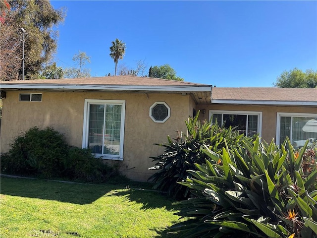 2609 E Cortez St, West Covina, CA 91791 - view of property exterior with stucco siding, roof with shingles, and a yard