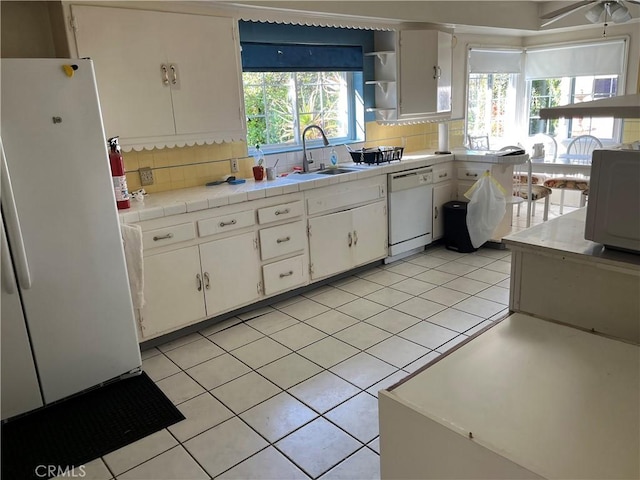 2609 E Cortez St, West Covina, CA 91791 - kitchen featuring tile counters, white cabinets, backsplash, a sink, and white appliances
