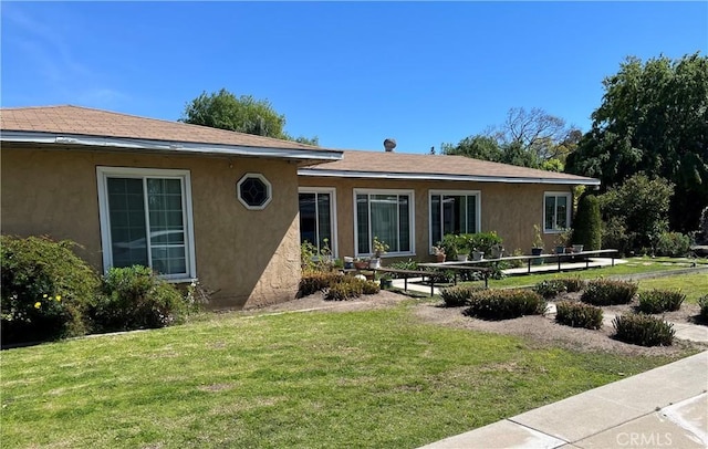 2609 E Cortez St, West Covina, CA 91791 - rear view of property featuring stucco siding and a yard