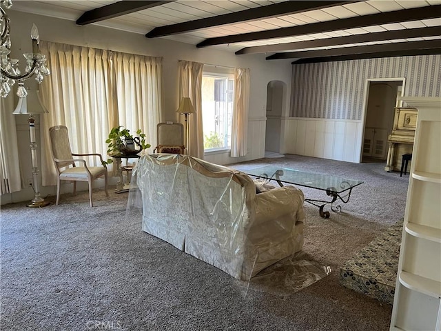 2609 E Cortez St, West Covina, CA 91791 - carpeted living room featuring wainscoting, arched walkways, and beam ceiling