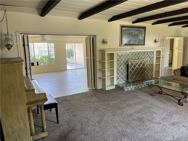 2609 E Cortez St, West Covina, CA 91791 - carpeted living room featuring tile patterned flooring, a high end fireplace, beam ceiling, and a ceiling fan