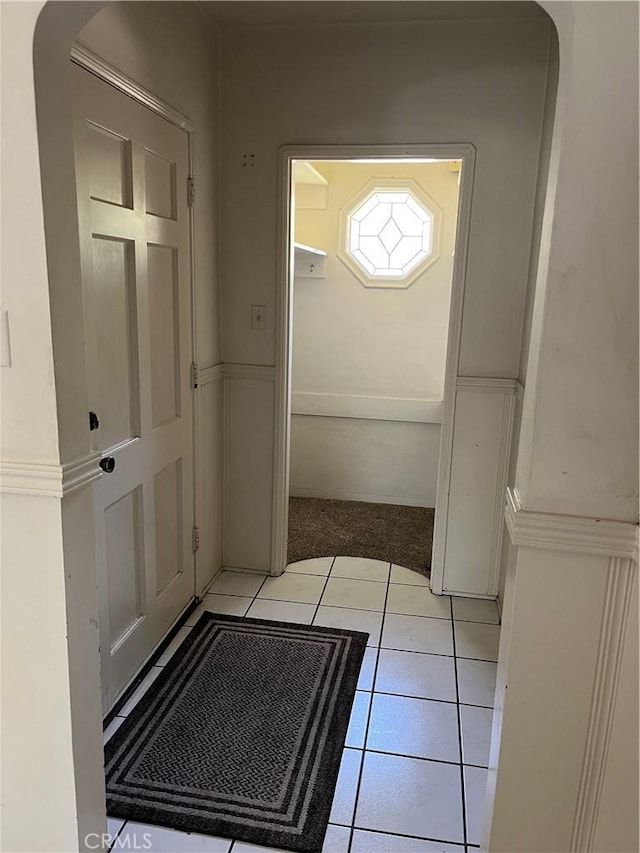 2609 E Cortez St, West Covina, CA 91791 - doorway with a wainscoted wall, a decorative wall, light colored carpet, and light tile patterned flooring