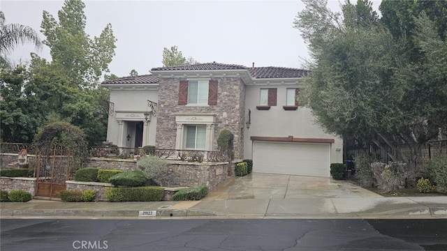 29123 Black Pine Way, Saugus, CA 91390 - mediterranean / spanish-style house with stucco siding, stone siding, an attached garage, a tile roof, and driveway