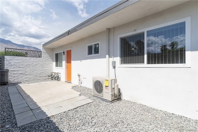 view of patio / terrace featuring ac unit and a mountain view