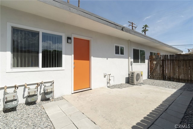 exterior space featuring ac unit, fence, a patio, and stucco siding