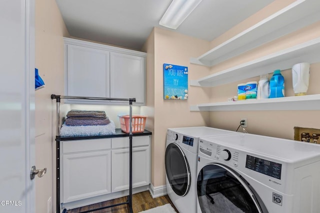 laundry room with cabinet space, dark wood-type flooring, and separate washer and dryer