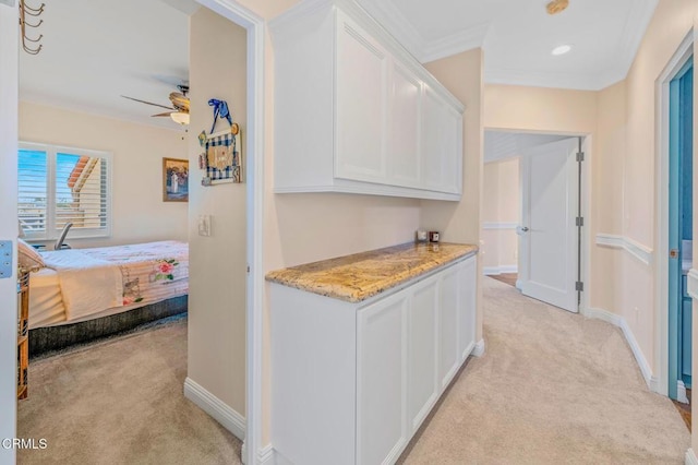 hallway featuring crown molding, recessed lighting, baseboards, and light carpet