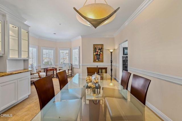 dining room featuring baseboards and ornamental molding