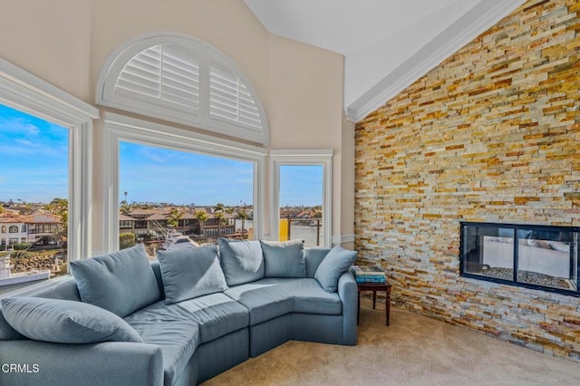 sunroom / solarium featuring a wealth of natural light, lofted ceiling, and a fireplace