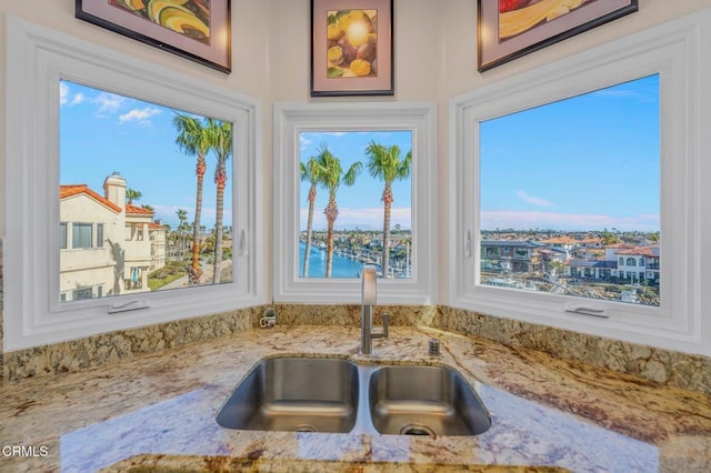 room details with light stone counters and a sink