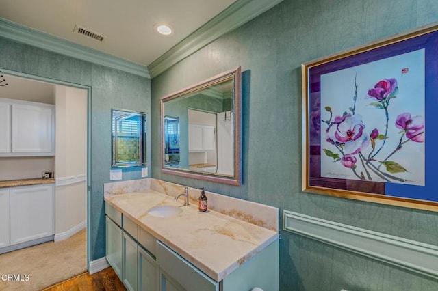 bathroom featuring visible vents, vanity, and crown molding