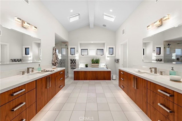 bathroom featuring a stall shower, a sink, and tile patterned floors