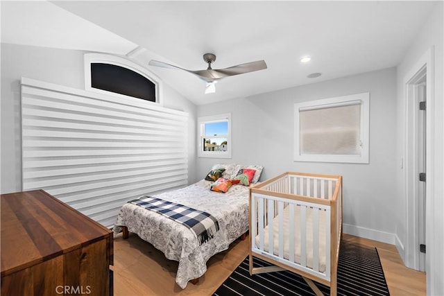 bedroom featuring ceiling fan, recessed lighting, wood finished floors, baseboards, and vaulted ceiling