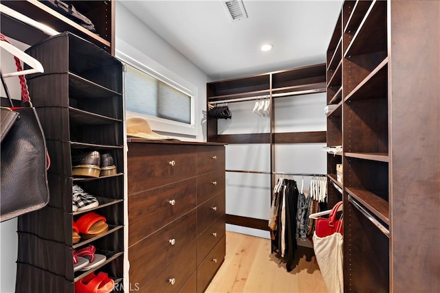 spacious closet featuring wood finished floors and visible vents