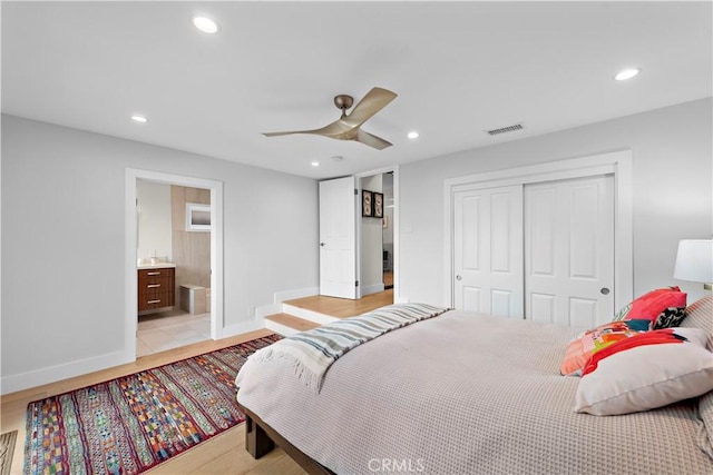 bedroom with baseboards, visible vents, light wood-type flooring, a closet, and recessed lighting