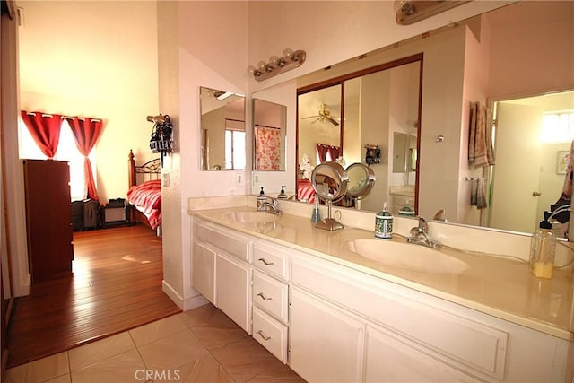 ensuite bathroom featuring double vanity, tile patterned flooring, ensuite bath, and a sink