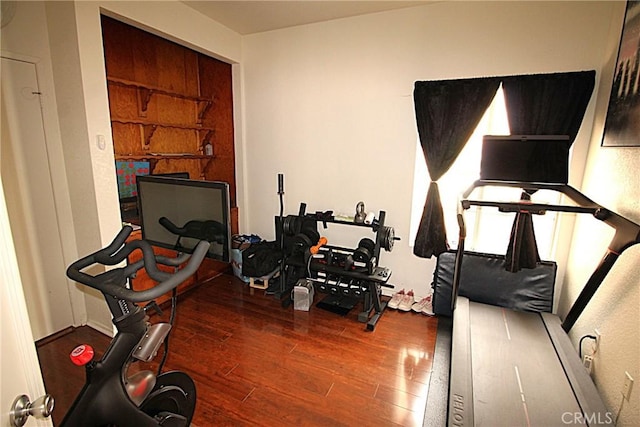 exercise room with wood finished floors