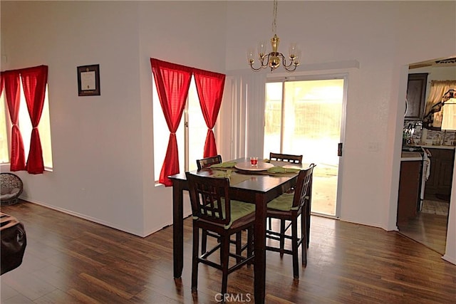 dining room featuring dark wood-style floors and an inviting chandelier