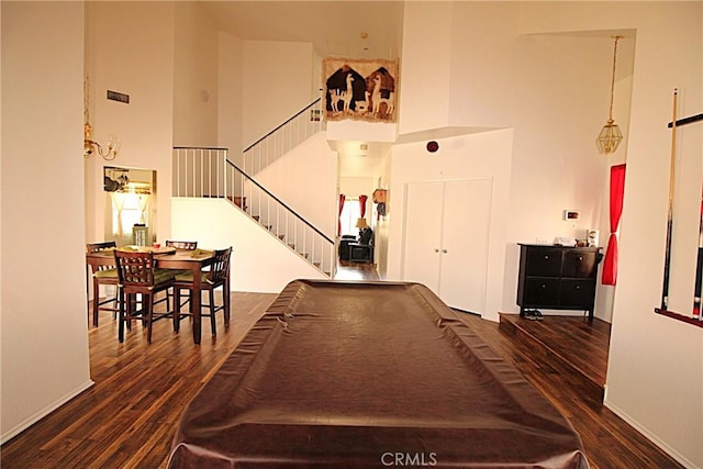 recreation room featuring billiards, a high ceiling, baseboards, and wood finished floors