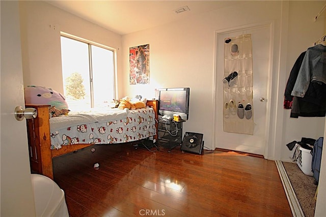 bedroom featuring visible vents and hardwood / wood-style floors