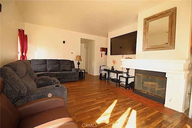 living room with a fireplace with flush hearth and wood finished floors