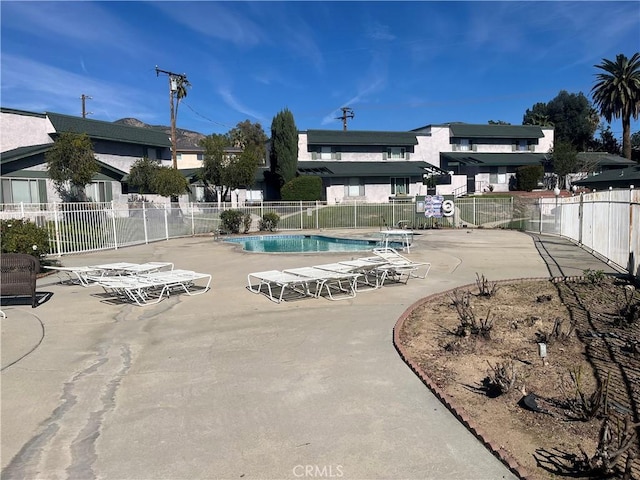 pool featuring a patio area and fence