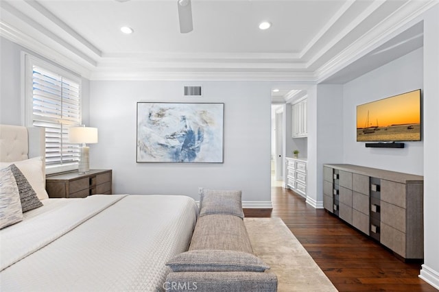 bedroom featuring dark wood finished floors, a raised ceiling, visible vents, and baseboards