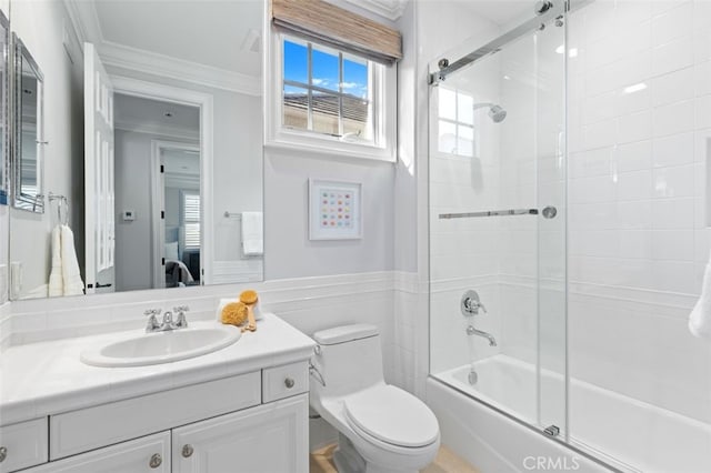 full bath featuring toilet, combined bath / shower with glass door, ornamental molding, and vanity