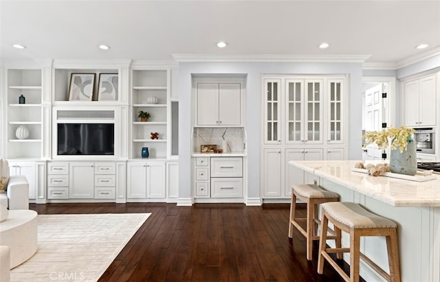 interior space featuring dark wood-style floors, recessed lighting, crown molding, and decorative backsplash