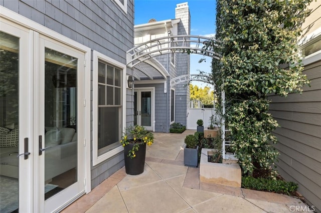 view of patio / terrace featuring french doors and fence