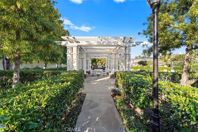 view of property's community with a patio and a pergola