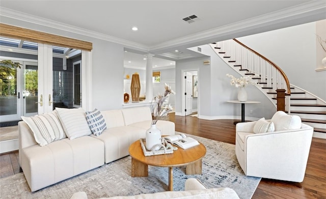 living area with stairs, ornamental molding, wood finished floors, and visible vents