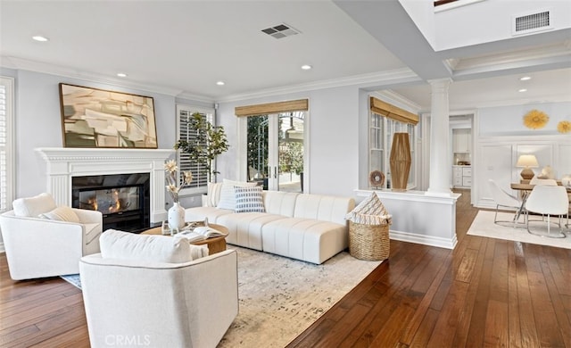 living room with visible vents, a fireplace, and ornate columns