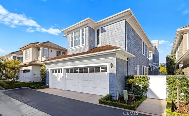 view of front facade featuring a garage, fence, and driveway