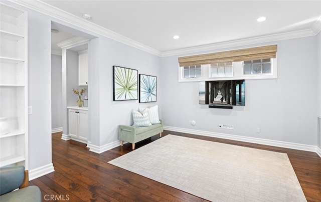 unfurnished room featuring built in shelves, recessed lighting, baseboards, ornamental molding, and dark wood finished floors