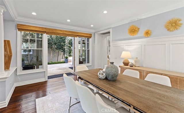 dining space featuring recessed lighting, crown molding, a decorative wall, and hardwood / wood-style flooring