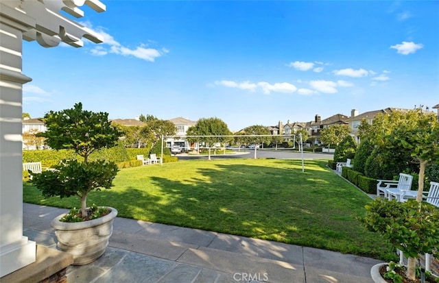 view of yard with a residential view and volleyball court