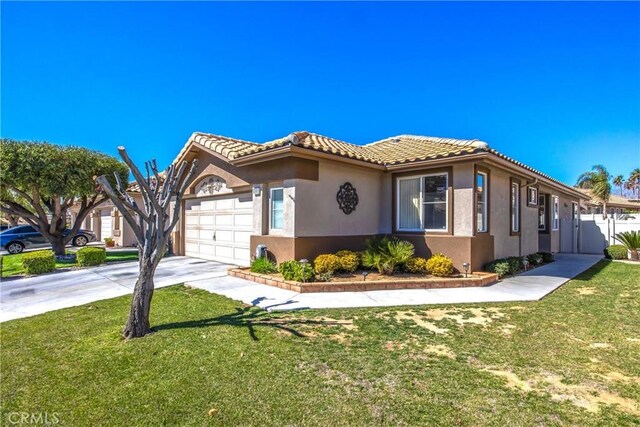 view of front of home featuring a tile roof, stucco siding, concrete driveway, a front yard, and a garage