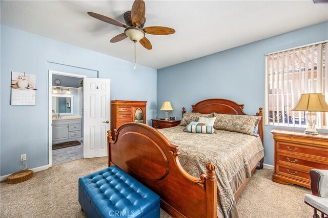 5855 Myrtle Beach Dr, Banning, CA 92220 - bedroom with light carpet, baseboards, ensuite bathroom, and a ceiling fan