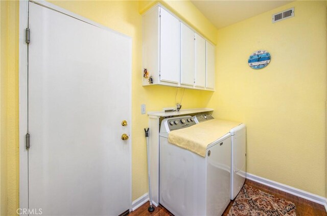 5855 Myrtle Beach Dr, Banning, CA 92220 - washroom with washer and dryer, cabinet space, dark wood-style floors, and baseboards
