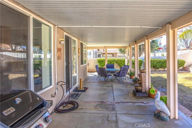 view of patio featuring fence and outdoor dining area